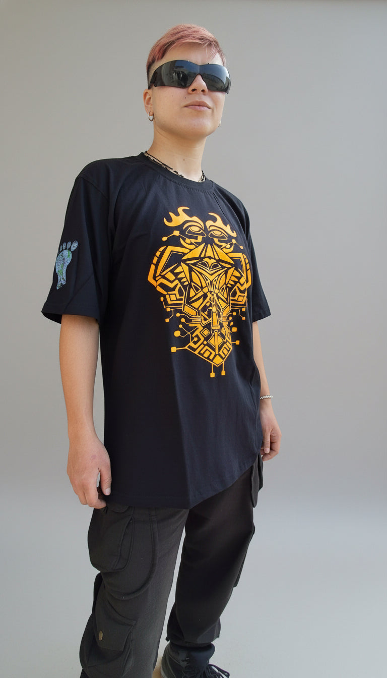 Person wearing a black hoodie with a yellow design, standing on stone steps.